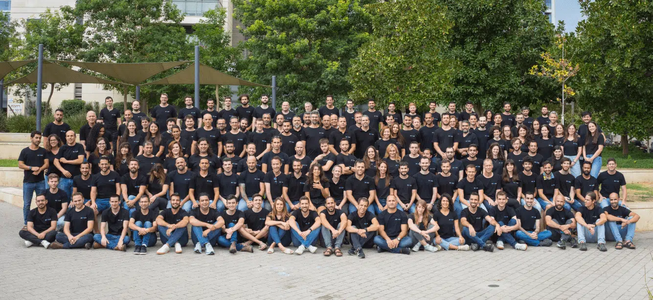 A group of people in black shirts posing for a photo.